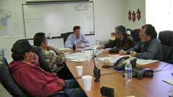 Photo of representatives from the Navajo Nation (Albert Damon, Tony Perry, and Franklin Jishie) discuss the Fort Wingate project with Steven Smith and Mike Chee. 