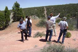 Photo of Steven Smith, Mike Scoville, and Steven Carpenter describe the Hazardous Waste Management Unit in Parcel 3 to the Zuni Government Delegation. 