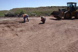 Photo of contractor personnel performing final inspection and cleanup of debris removal.