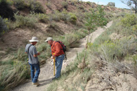 Photo of ordnance and environmental specialists are conducting survey of another arroyo, looking for UXO.